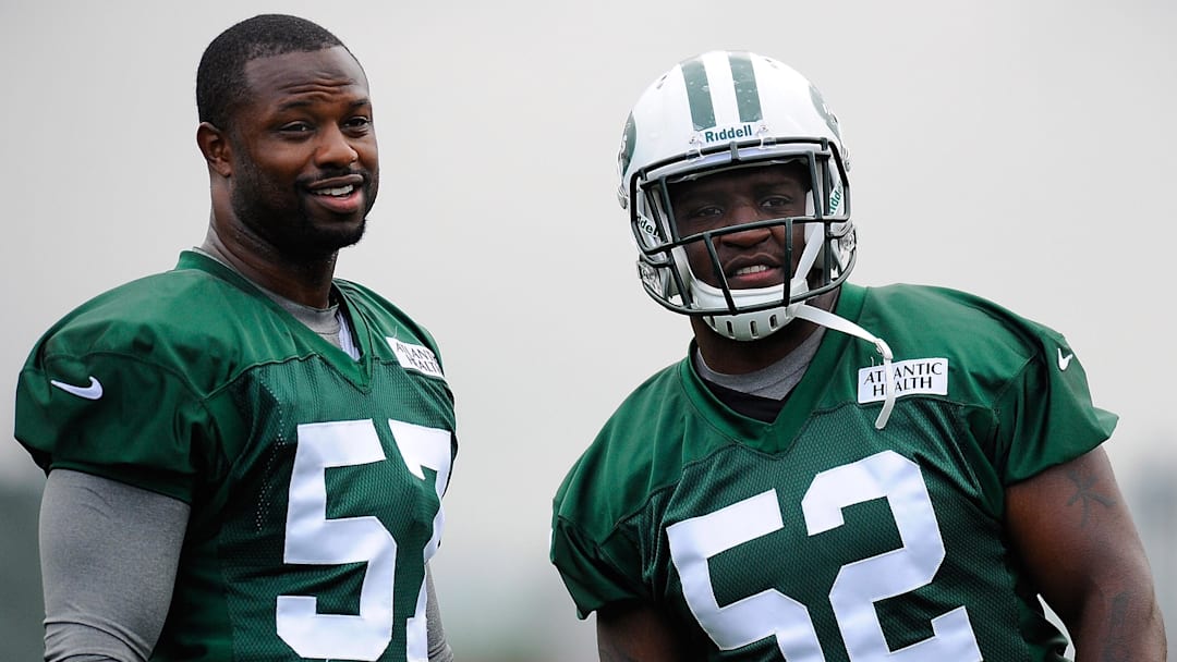 July 27, 2012; Cortland, NY, USA; New York Jets linebackers Bart Scott (57) and David Harris (52) look on during training camp at SUNY Cortland. Mandatory Credit: Rich Barnes-Imagn Images