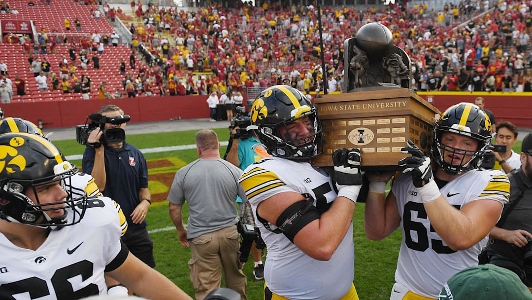 Iowa Football team celebrates with Cy-Hawk trophy after winning 20-13 over Iowa State at the Jack Trice Stadium on Saturday, Sept. 9, 2023, in Ames, Iowa.