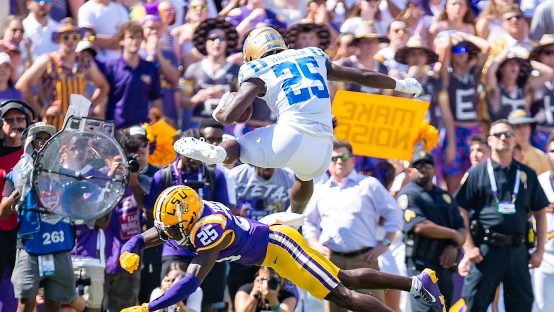 Bruins runningback TJ Harden 25 leaps over Tiger Javien Toviano 25 as the LSU Tigers take on UCLA at Tiger Stadium in Baton Rouge, LA. Saturday, Sept. 21, 2024.