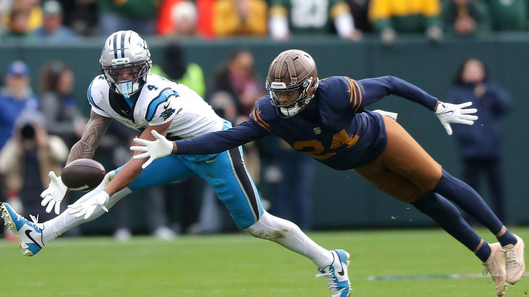 Green Bay Packers cornerback Carrington Valentine (24) breaks up a pass to Carolina Panthers wide receiver Tetairoa McMillan 