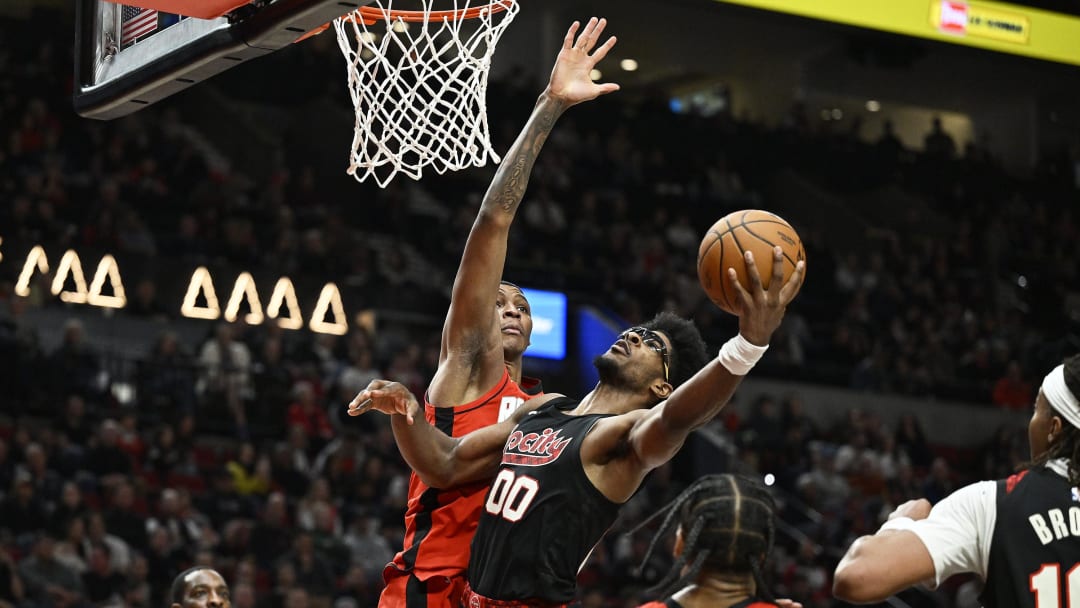 Apr 12, 2024; Portland, Oregon, USA; Portland Trail Blazers guard Scoot Henderson (00) drives to the basket during the second half against Houston Rockets forward Jabari Smith Jr. (10) at Moda Center. Mandatory Credit: Troy Wayrynen-USA TODAY Sports