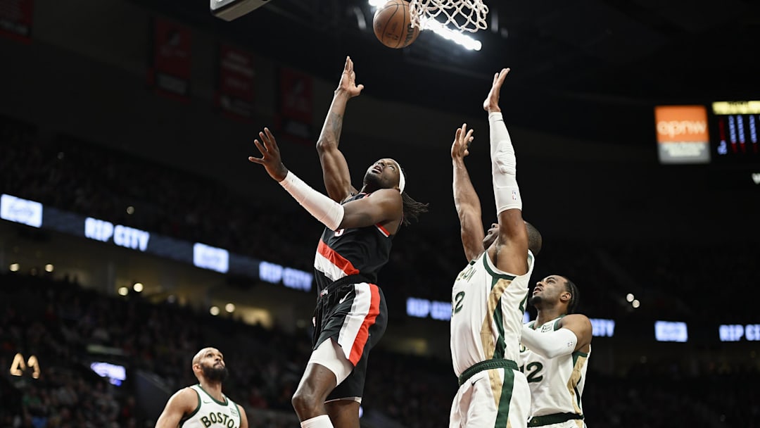 Mar 11, 2024; Portland, Oregon, USA; Portland Trail Blazers forward Jerami Grant (9) scores a basket during the first half against Boston Celtics center Al Horford (42) at Moda Center. Mandatory Credit: Troy Wayrynen-Imagn Images
