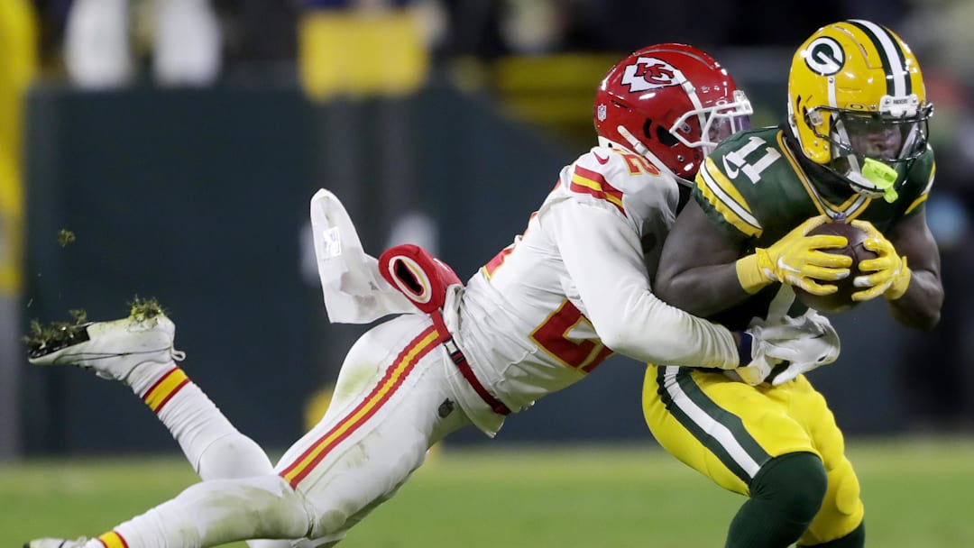 Dec 3, 2023; Green Bay, Wisconsin, USA; Green Bay Packers wide receiver Jayden Reed (11) is tackled by Kansas City Chiefs cornerback Trent McDuffie (22) following a pass reception at Lambeau Field. Mandatory Credit: Wm. Glasheen-Imagn Images