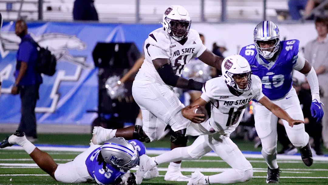 Missouri State quarterback Deuce Bailey (16) runs the ball as Middle Tennessee linebacker Muaaz Byard (35) makes the stop during the football game on Wednesday, October 8, 2025, at MTSU.