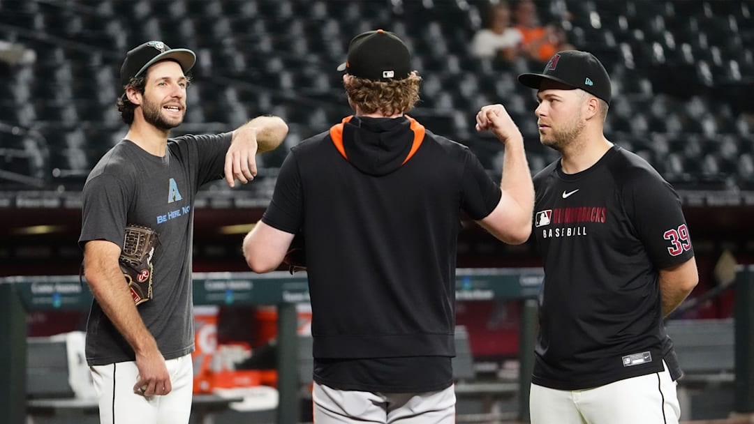 Arizona Diamondbacks pitchers Zac Gallen and Corbin Burnes chat with San Francisco Giants pitcher Logan Webb (center) before their game at Chase Field on Sept. 17. Arizona Diamondbacks pitchers Zac Gallen and Corbin Burnes chat with San Francisco Giants pitcher Logan Webb (center) before their game at Chase Field on Sept. 17.