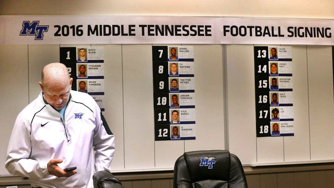 MTSU head football Coach Rick Stockstill looks at his phone, in the football conference room, in front of a wall where new MTSU signees have been added as their paperwork arrives to the office, on Wednesday, Feb. 3, 2016, National Signing Day.

636691704512119581-71-MTSU-Coach-Rick-Stockstill.JPG
