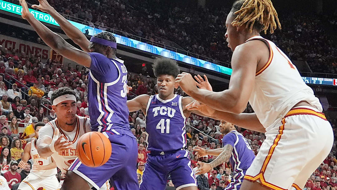 Iowa State Cyclones guard Tamin Lipsey (3) passes the ball to center Dishon Jackson (1) around TCU Horned Frogs center Malick Diallo (32) during the first half in the Big-12 men’s basketball at Hilton Coliseum on Feb 8, 2025 in Ames, Iowa.