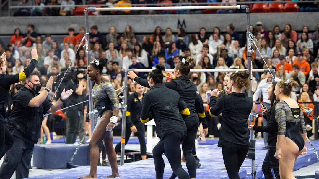 Amari Celestine celebrates after sticking her landing on the bars as Auburn gymnastics takes on Missouri at Auburn Arena in Auburn, Ala., on Friday, Feb. 11, 2022. Auburn defeated Missouri 197.575-196.275.