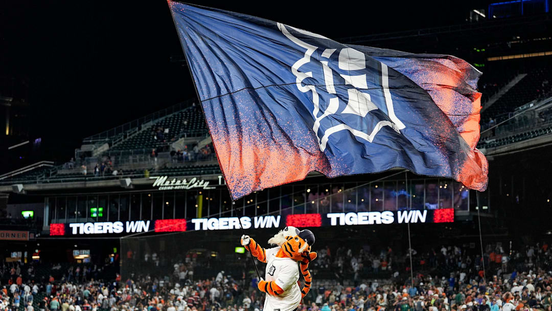 Detroit Tigers mascot Paws waves a flag to celebrate a win at Comerica Park. 