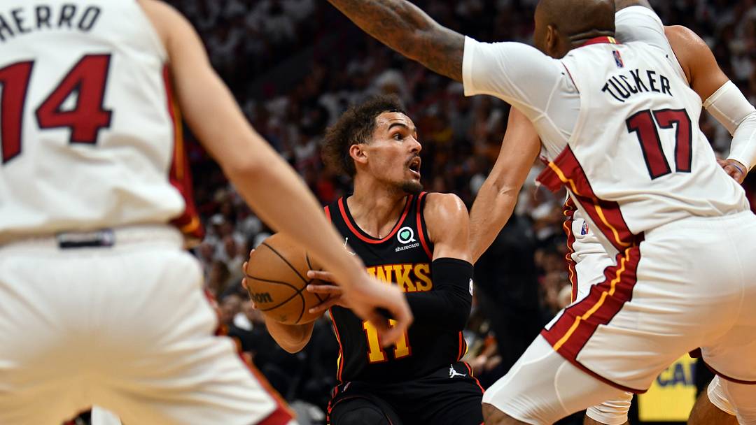 Apr 17, 2022; Miami, Florida, USA; Atlanta Hawks guard Trae Young (11) looks to pass the ball as Miami Heat forward P.J. Tucker (17) and teammate guard Tyler Herro (14) defend during the second half of game one of the first round for the 2022 NBA playoffs at FTX Arena. Mandatory Credit: Jim Rassol-USA TODAY Sports