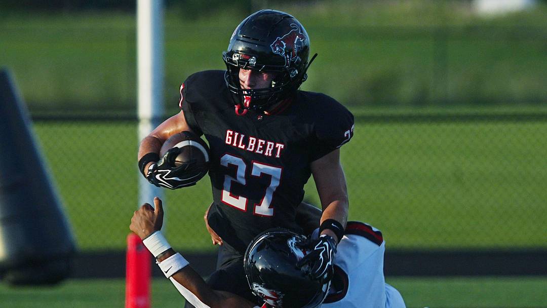 Gilbert running back Micah Leyva (27) battles for a few yard  as getting tackle by Mason City linebacker Parker Sgontz (8) during the first quarter in the week-2 Iowa high school football at Tiger Stadium on Sept. 4, 2026, in Gilbert, Iowa.