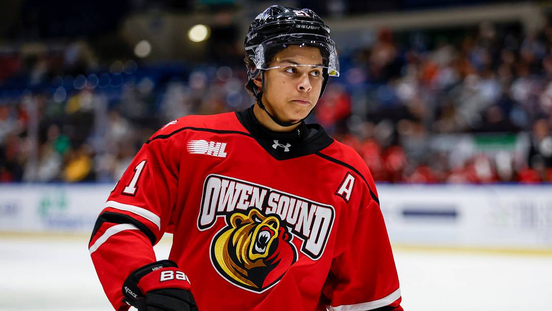 Owen Sound Attack forward Pierce Mbuyi #21 concentrates prior to the face-off during a game between Owen Sound Attack and Saginaw Spirit
