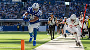 Former Wisconsin Badgers running back Jonathan Taylor (28) reaches for the pylon Sunday, Oct. 12, 2025, against the Arizona Cardinals at Lucas Oil Stadium in Indianapolis.
