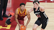 Iowa State Cyclones forward Joshua Jefferson (2) passes the ball around Cincinnati Bearcats' guard/forward Simas Lukošius (41) during the first half in the Big-12 men’s basketball at Hilton Coliseum on Feb. 15, 2025 in Ames, Iowa.