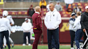 Nov 23, 2024; Minneapolis, Minnesota, USA; Minnesota Golden Gophers head coach P.J. Fleck and Penn State Nittany Lions head coach James Franklin talk before the game at Huntington Bank Stadium. Mandatory Credit: Matt Krohn-Imagn Images