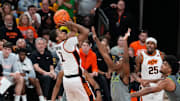 Mar 1, 2025; Waco, Texas, USA;  Oklahoma State Cowboys guard Bryce Thompson (1) scores a basket over Baylor Bears guard Robert Wright III (1) during the second half at Paul and Alejandra Foster Pavilion. Mandatory Credit: Chris Jones-Imagn Images