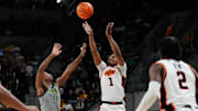 Mar 1, 2025; Waco, Texas, USA; Oklahoma State Cowboys guard Bryce Thompson (1) shoots as Baylor Bears guard Robert Wright III (1) defends during the first half at Paul and Alejandra Foster Pavilion. Mandatory Credit: Chris Jones-Imagn Images