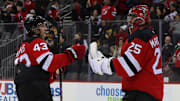 Dec 21, 2024; Newark, New Jersey, USA; New Jersey Devils defenseman Luke Hughes (43) and goaltender Jacob Markstrom (25) celebrate their win over the Pittsburgh Penguins at Prudential Center. Mandatory Credit: Ed Mulholland-Imagn Images