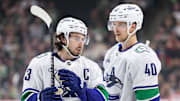 Dec 3, 2024; Saint Paul, Minnesota, USA;Vancouver Canucks defenseman Quinn Hughes (43) and center Elias Pettersson (40) talk before a power play against the Minnesota Wild during the first period at Xcel Energy Center. Mandatory Credit: Matt Krohn-Imagn Images