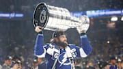 Jul 7, 2021; Tampa, Florida, USA; Tampa Bay Lightning left wing Pat Maroon (14) hoists the Stanley Cup after the Lightning defeated the Montreal Canadiens 1-0 in game five to win the 2021 Stanley Cup Final at Amalie Arena. Mandatory Credit: Kim Klement-Imagn Images