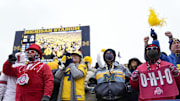 Ohio State Buckeyes and Michigan Wolverines fans react to a Hassan Haskins touchdown during the third quarter of the NCAA football game at Michigan Stadium in Ann Arbor on Saturday, Nov. 27, 2021.