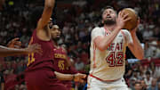 Mar 10, 2023; Miami, Florida, USA;  Miami Heat forward Kevin Love (42) grabs a rebound as Cleveland Cavaliers center Jarrett Allen (31) defends in the first half at Miami-Dade Arena. Mandatory Credit: Jim Rassol-Imagn Images