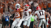 Texas Longhorns running back Jaydon Blue scores a touchdown against Georgia Bulldogs defensive back Daylen Everette, left, and Georgia Bulldogs defensive back Dan Jackson in the third quarter at Darrell K Royal-Texas Memorial Stadium Saturday October 19, 2024.