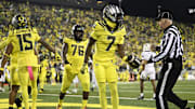 Oct 4, 2024; Eugene, Oregon, USA; Oregon Ducks wide receiver Evan Stewart (7) gives the football to a referee after scoring a touchdown during the first half against the Michigan State Spartans at Autzen Stadium. 