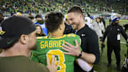 Nov 9, 2024; Eugene, Oregon, USA; Oregon Ducks head coach Dan Lanning celebrates with quarterback Dillon Gabriel (8) after beating the Maryland Terrapins at Autzen Stadium. Mandatory Credit: Troy Wayrynen-Imagn Images