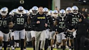 Nov 30, 2024; Eugene, Oregon, USA; Oregon Ducks head coach Dan Lanning runs out with the team before a game against the Washington Huskies at Autzen Stadium. Mandatory Credit: Troy Wayrynen-Imagn Images