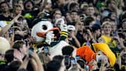 Oct 12, 2024; Eugene, Oregon, USA; The Oregon Duck mascot celebrates with fans in the second half against Ohio State Buckeyes during the NCAA football game at Autzen Stadium.