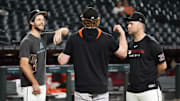 Arizona Diamondbacks pitchers Zac Gallen and Corbin Burnes chat with San Francisco Giants pitcher Logan Webb (center) before their game at Chase Field on Sept. 17.