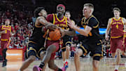 Iowa State Cyclones forward Killyan Toure (27) drives to the basket as Iowa Hawkeyes guard Kael Combs (11) and I guard Bennett Stirtz (14) defend and fouled during the second half in the men’s basketball Cy-Hawk series on Dec. 11, 2025, in Ames, Iowa.