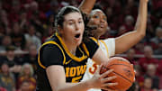 Iowa Hawkeyes center Ava Heiden (5) drives to the basket around Iowa State Cyclones' forward Alisa Williams (3) during the first quarter in the NCAA women’s basketball Cy-Hawk Series on Dec. 10, 2025, at Hilton Coliseum in Ames, Iowa.