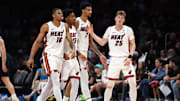 Oct 8, 2025; Miami, Florida, USA;  Miami Heat guard Kasparas Jakucionis (25) is congratulated by forward Keshad Johnson (16), forward Myron Gardner (15) and center Kel'El Ware (7) during a timeout in the second half against the San Antonio Spurs at Kaseya Center. Mandatory Credit: Jim Rassol-Imagn Images
