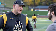 Head Coach Shawn Clark speaks to Asheville Citizen-Times sports reporter Evan Gerike after the AppState Mountaineers' football practice at Appalachian State University in Boone, NC, on Wednesday, Oct. 23, 2024.