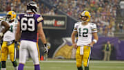 Oct 23, 2011; Minneapolis, MN, USA; Green Bay Packers quarterback Aaron Rodgers (12) talks with Minnesota Vikings defensive end Jared Allen (69) during a break on the field in the second quarter at the Metrodome. Mandatory Credit: Bruce Kluckhohn-Imagn Images