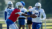 Indianapolis Colts quarterback Anthony Richardson Sr. (5) hands off to Indianapolis Colts running back DJ Giddens (21) on Wednesday, July 23, 2025, during the first day of training camp held at Grand Park in Westfield.