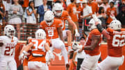 The Texas Orange team celebrate a touchdown catch by wide receiver Ryan Wingo (5) in the fourth quarter of the Spring Game