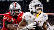 Texas Longhorns running back Jaydon Blue (23) runs into the end zone to score after catching a pass from quarterback Quinn Ewers (3) while Ohio State Buckeyes safety Sonny Styles (6) runs to defend late in the second quarter as the Texas Longhorns play the Ohio State Buckeyes in the Cotton Bowl College Football Playoff semi-final at AT&T Stadium in Dallas, Texas, Jan. 10, 2025.