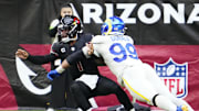 Arizona Cardinals quarterback Kyler Murray (1) is tackled by Los Angeles Rams defensive tackle Aaron Donald (99) in the second half at State Farm Stadium in Glendale on Nov. 26, 2023.