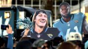 Oversized photos of Jacksonville Jaguars quarterback Trevor Lawrence (16) and teammate linebacker