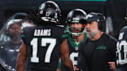 Oct 31, 2024; East Rutherford, New Jersey, USA; New York Jets wide receiver Davante Adams (17), quarterback Aaron Rodgers (8) and interim head coach Jeff Ulbrich celebrate Adams touchdown against the Houston Texans during the second half at MetLife Stadium. Mandatory Credit: Ed Mulholland-Imagn Images