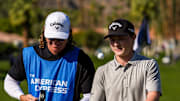 Blades Brown walks off the second green with his caddie during the first round of The American Express at La Quinta Country Club in La Quinta, Calif., Thursday, Jan. 16, 2025.