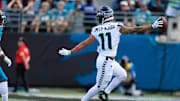 Caption:Seattle Seahawks wide receiver Jaxon Smith-Njigba (11) looks back at Jacksonville Jaguars cornerback Greg Newsome II (6) while scoring a touchdown during the second quarter of an NFL football matchup, Sunday, Oct. 12, 2025, at EverBank Stadium in Jacksonville, Fla. The Seahawks defeated the Jaguars 20-12.