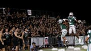 De La Salle defensive back Ant Dean (right) celebrates scoring his first varsity touchdown after ripping the ball out of the hands of QB Luke Alexander and returning it 33 yards for the score in a 42-14 victory Friday night in Concord, Calif. 