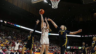 Iowa State Cyclones forward Addy Brown (24) takes a shot between West Virginia Mountaineers guard Lauren Fields (23) and forward Danelle Arigbabu (8) during the fourth quarter in the Big-12 conference matchup at Hilton Coliseum on Wednesday, Jan. 10, 2024, in Ames, Iowa.