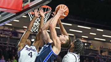 Noah Waterman is met at the rim against Kansas State