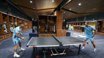 Two West Ham United players play ping-pong at the Seattle Seahawks practice facility. 