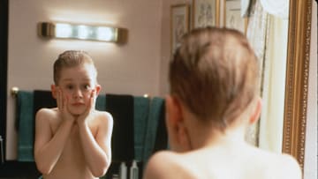 HOME ALONE - Eight year old Kevin MacAllister (Macaulay Culkin) gets lost in the shuffle as his large, upper-middle class suburban family rushes to make a plane that will ferry them off to their Christmas vacation in France; Kevin, having been banished to an attic room as punishment, is subsequently forgotten. At first this is a dream come true, as for the first time in his young life he has no one to answer to but himself, and he takes full advantage of his newfound freedom, eating junk food
